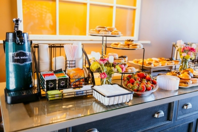 Breakfast includes various fruits, pastries, coffee, and tea